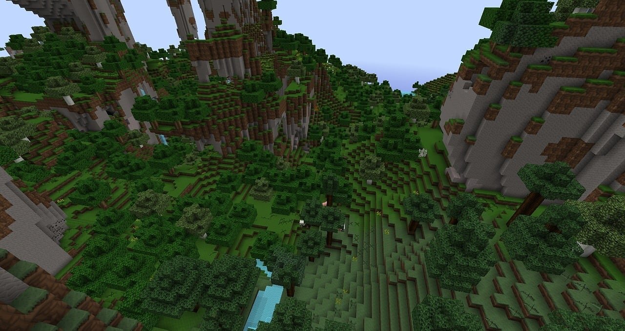 A misty forest canyon in Minecraft with tall stone cliffs